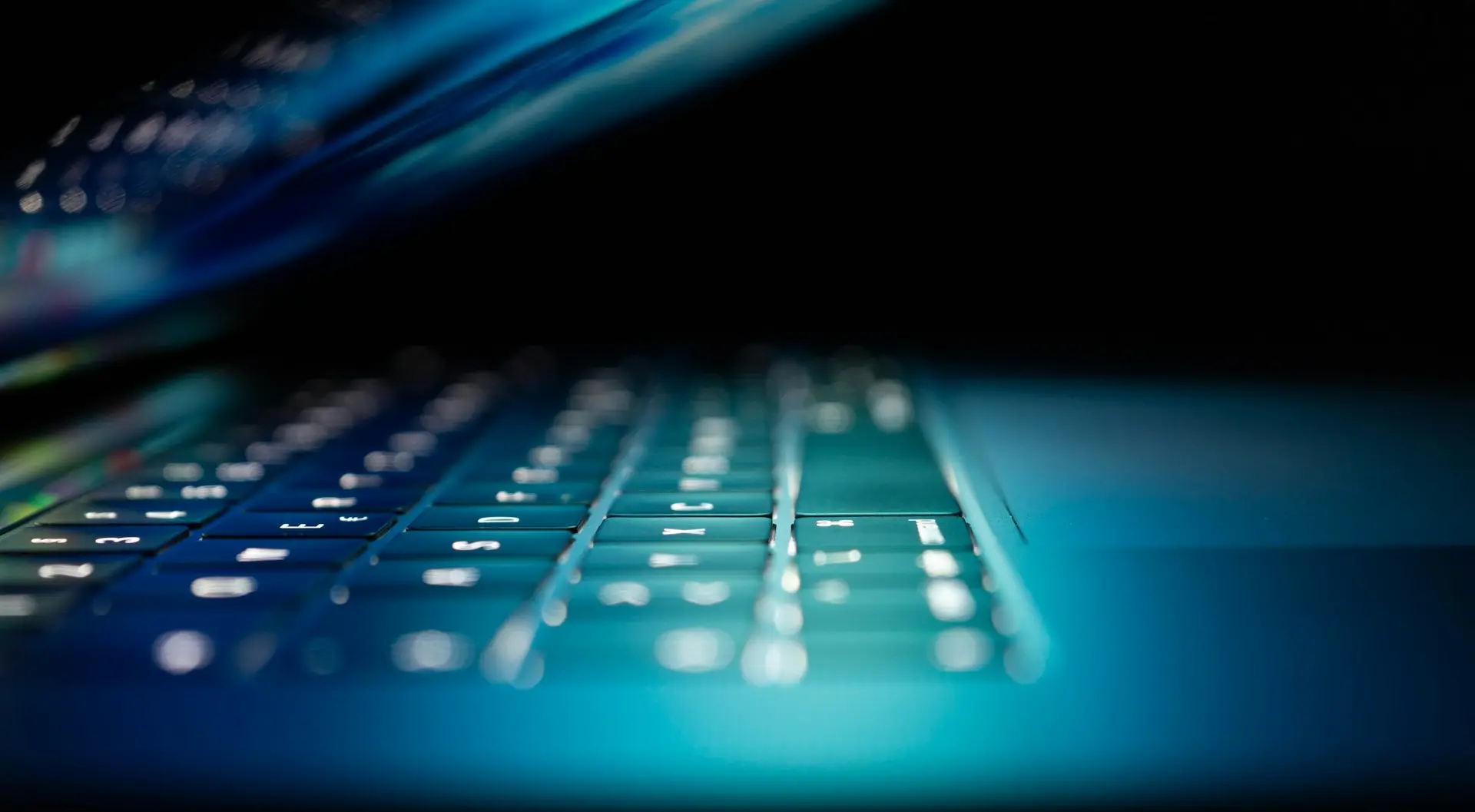 closeup photo of turned-on blue and white laptop computer
